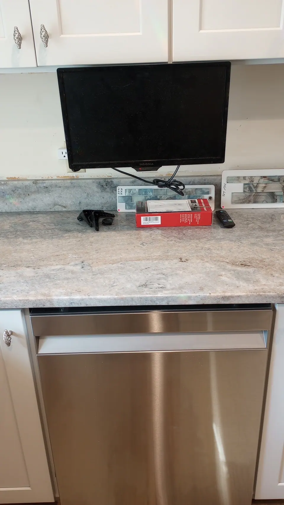 Dishwasher set into the light gray base run under the new counter.