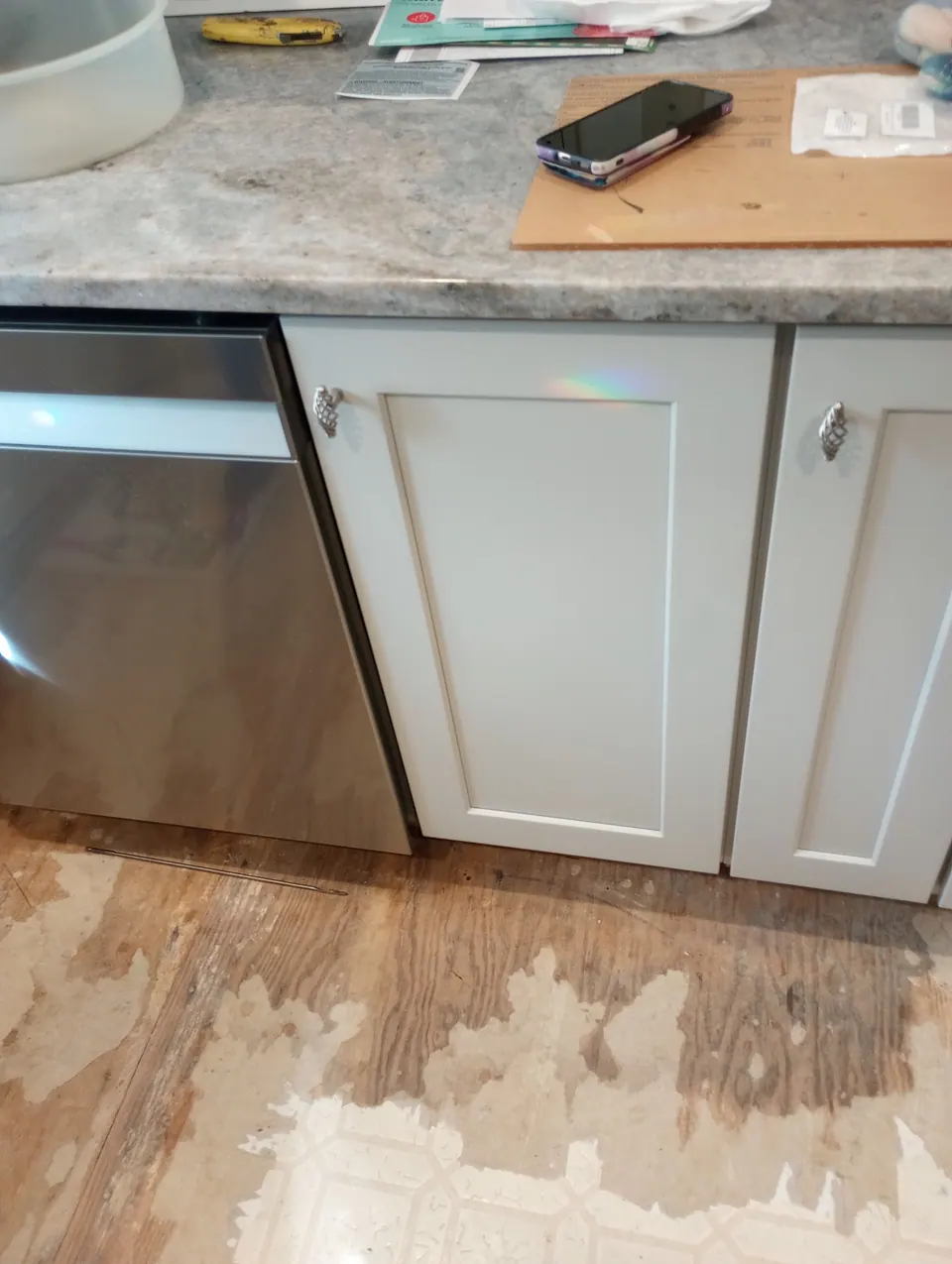 Light gray base cabinet and dishwasher at floor level.