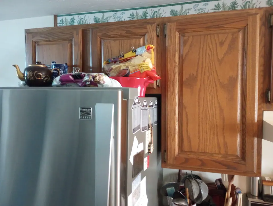 Before: oak wall cabinets over the refrigerator.