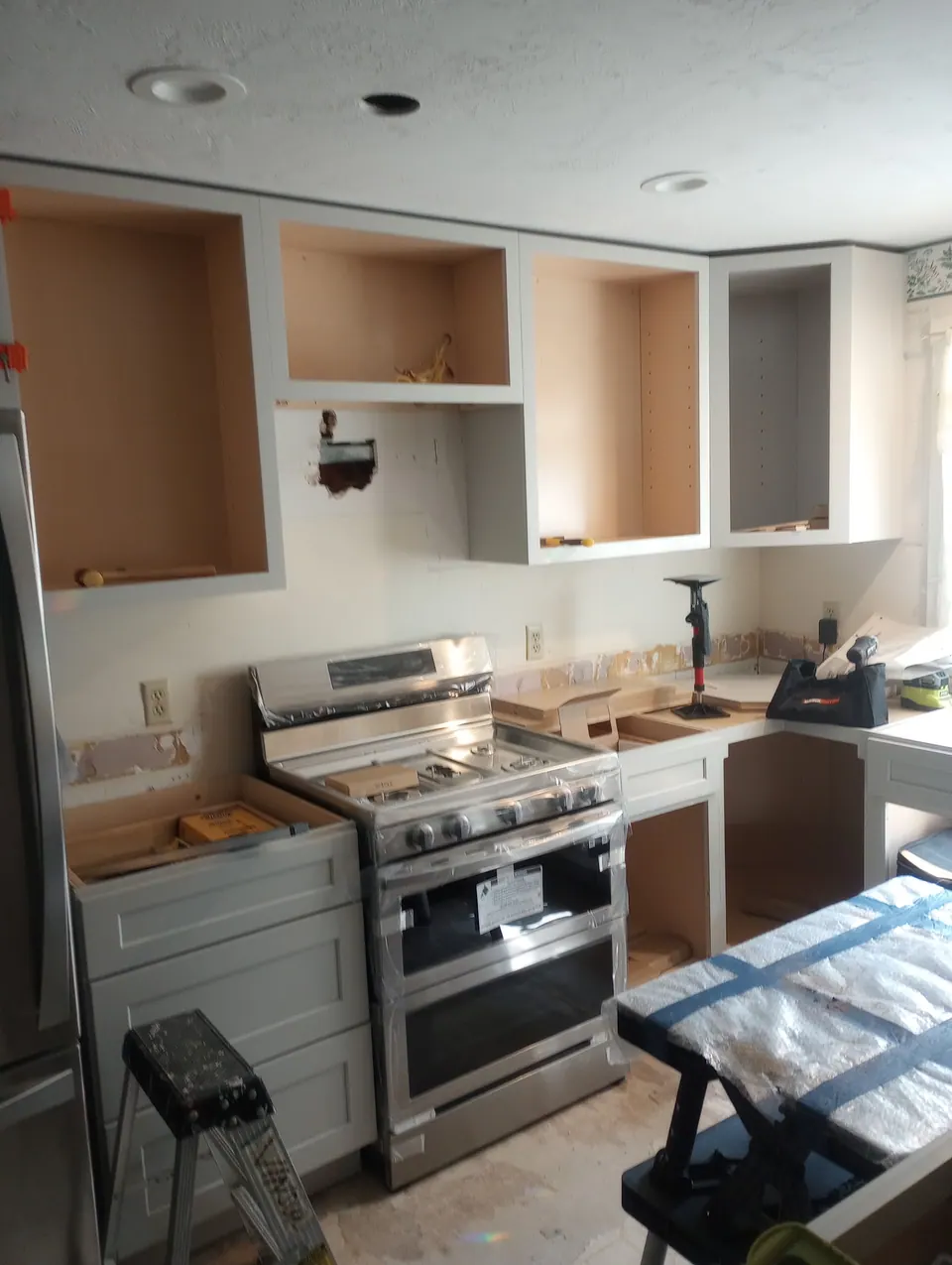 During the install: new light gray base cabinets in, wall boxes open.