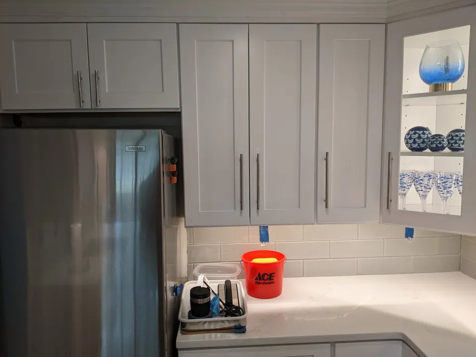 Light gray cabinets and the refrigerator.