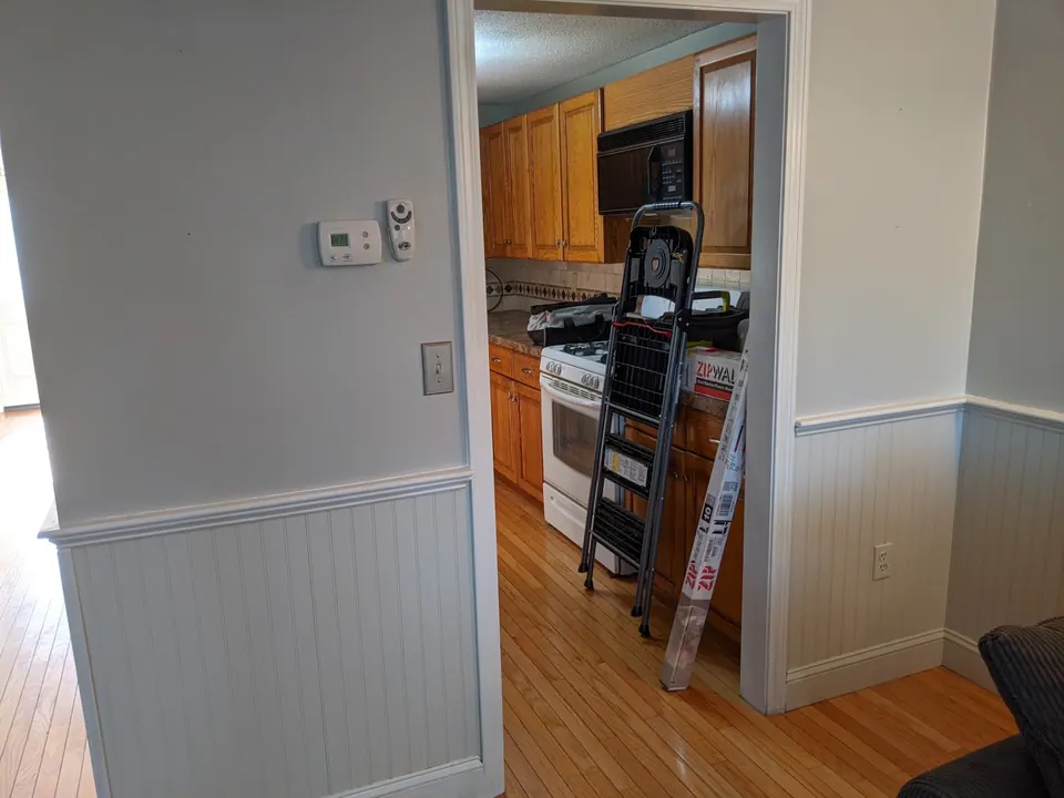 Before: the wall between the kitchen and the hall.