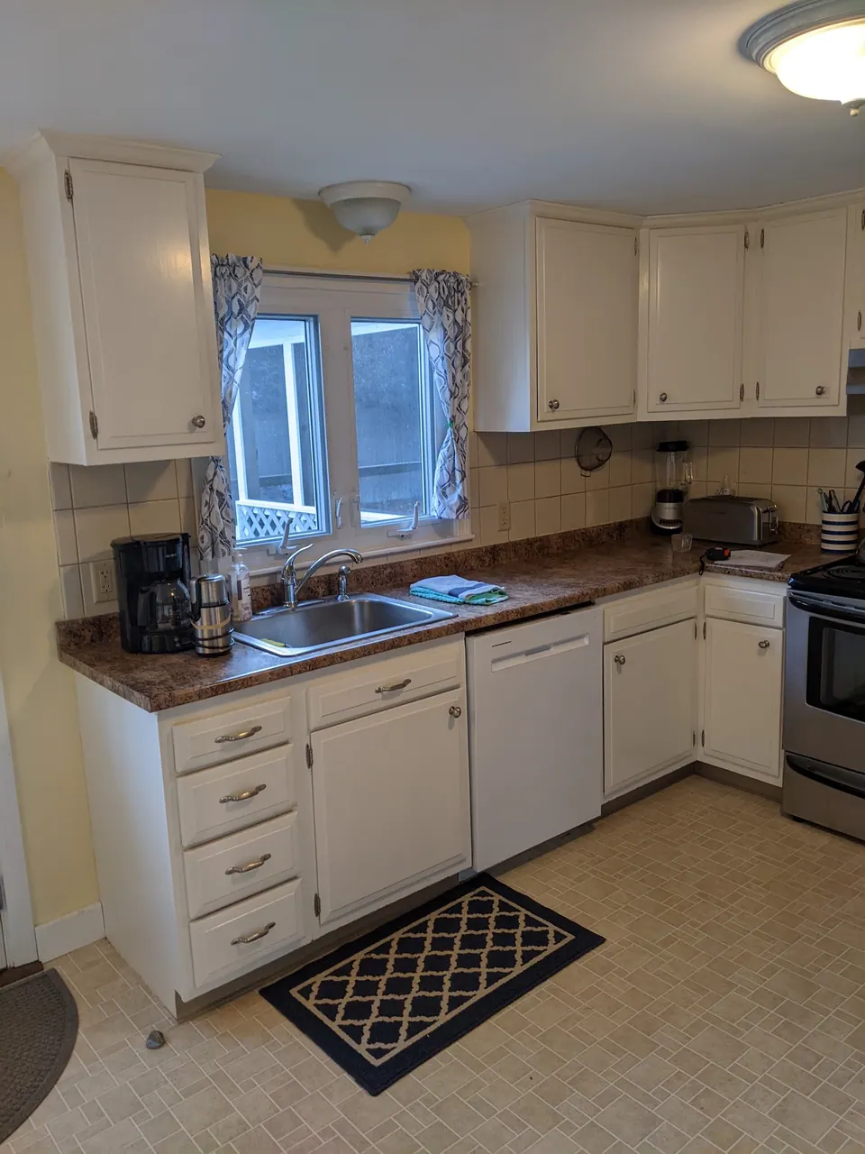 Before: the old white kitchen with laminate counters.
