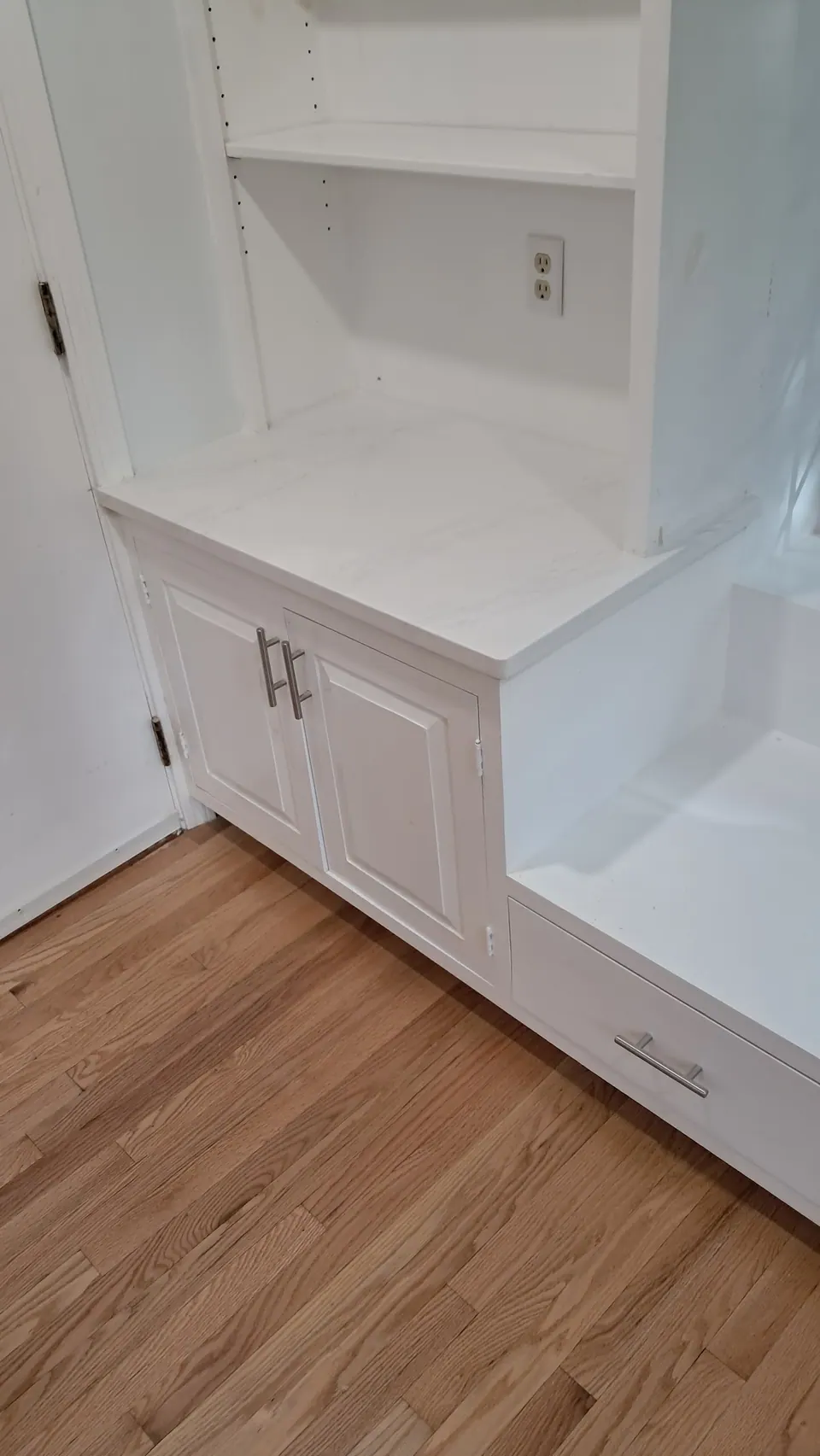 Corner of the dining room built-in: cabinet, open shelves and the window seat.