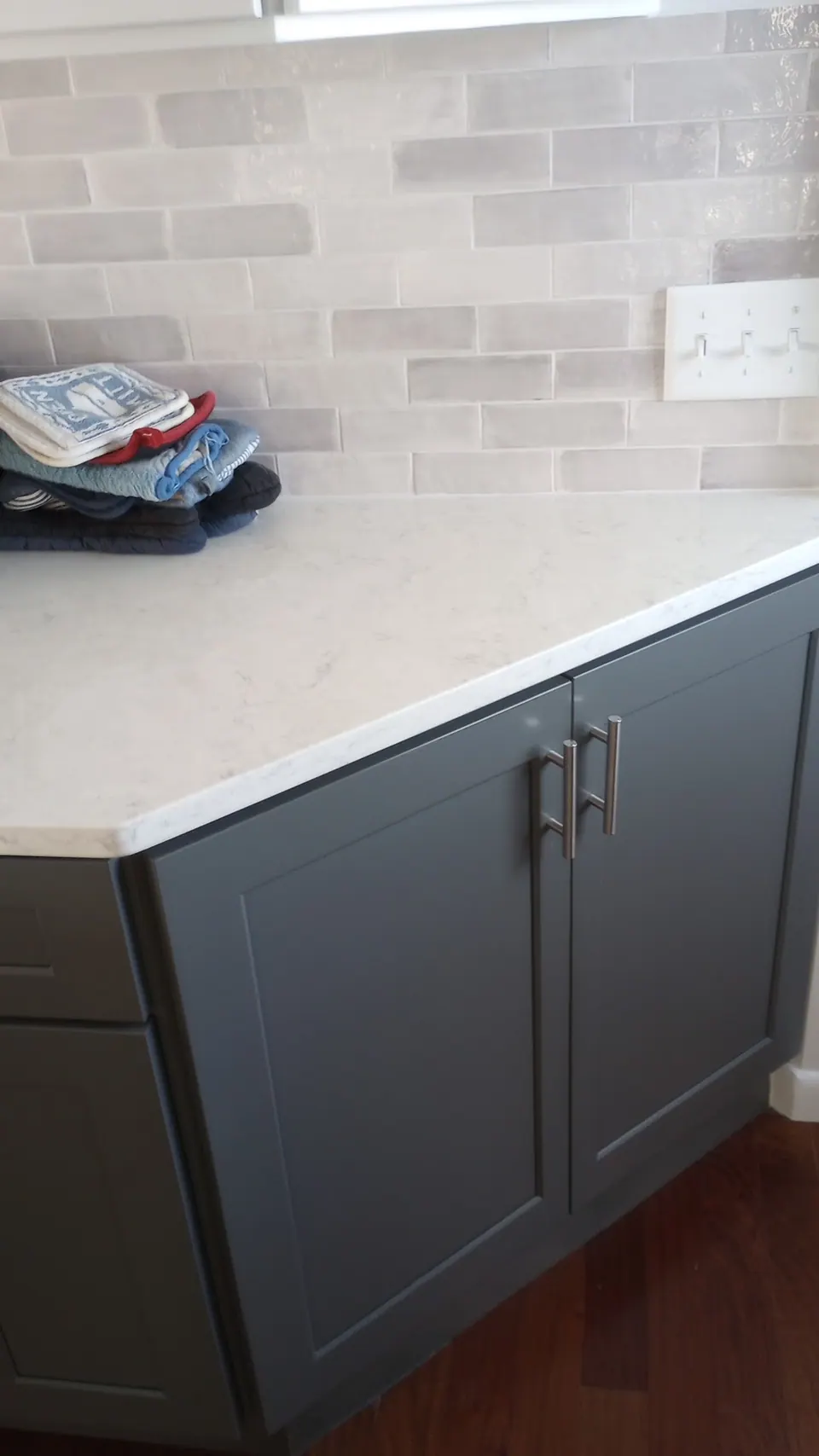 End of the dark gray peninsula with a white quartz top.