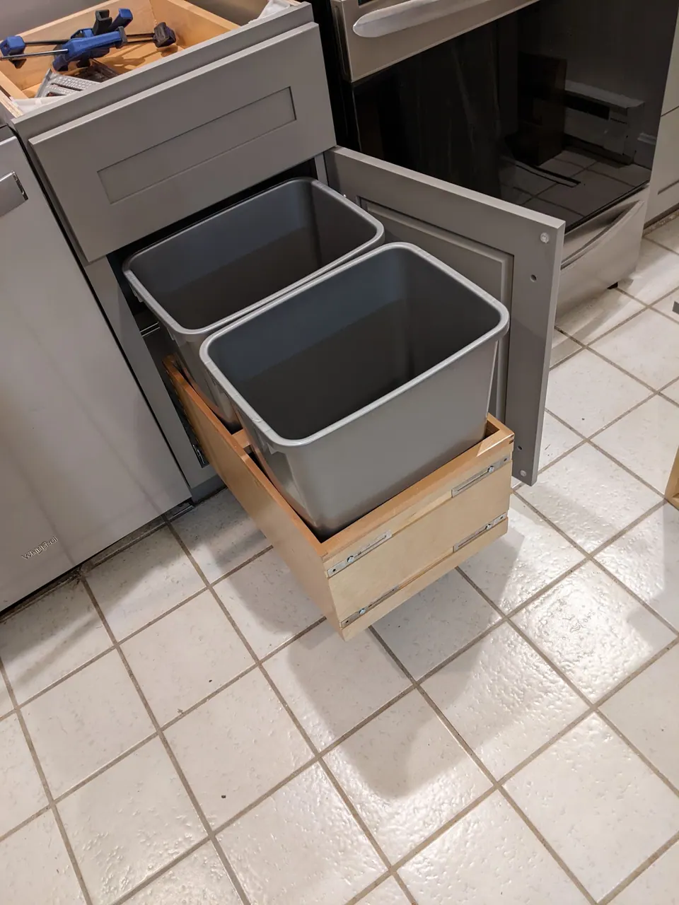 Pull-out trash base with two bins.