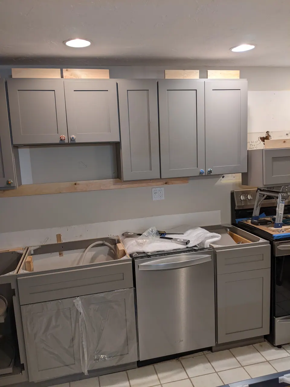 During the install: gray wall and base cabinets in.