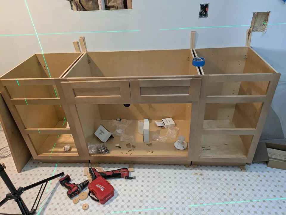 Vanity boxes set in place on the new mosaic floor before the doors go on.