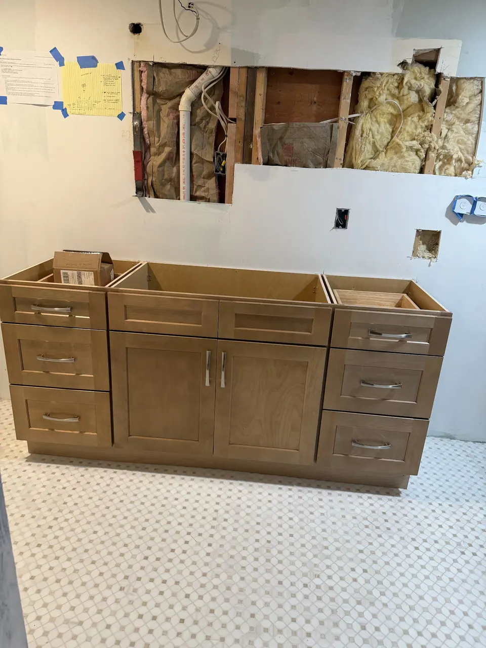 The vanity with doors and drawers on, waiting for its top.
