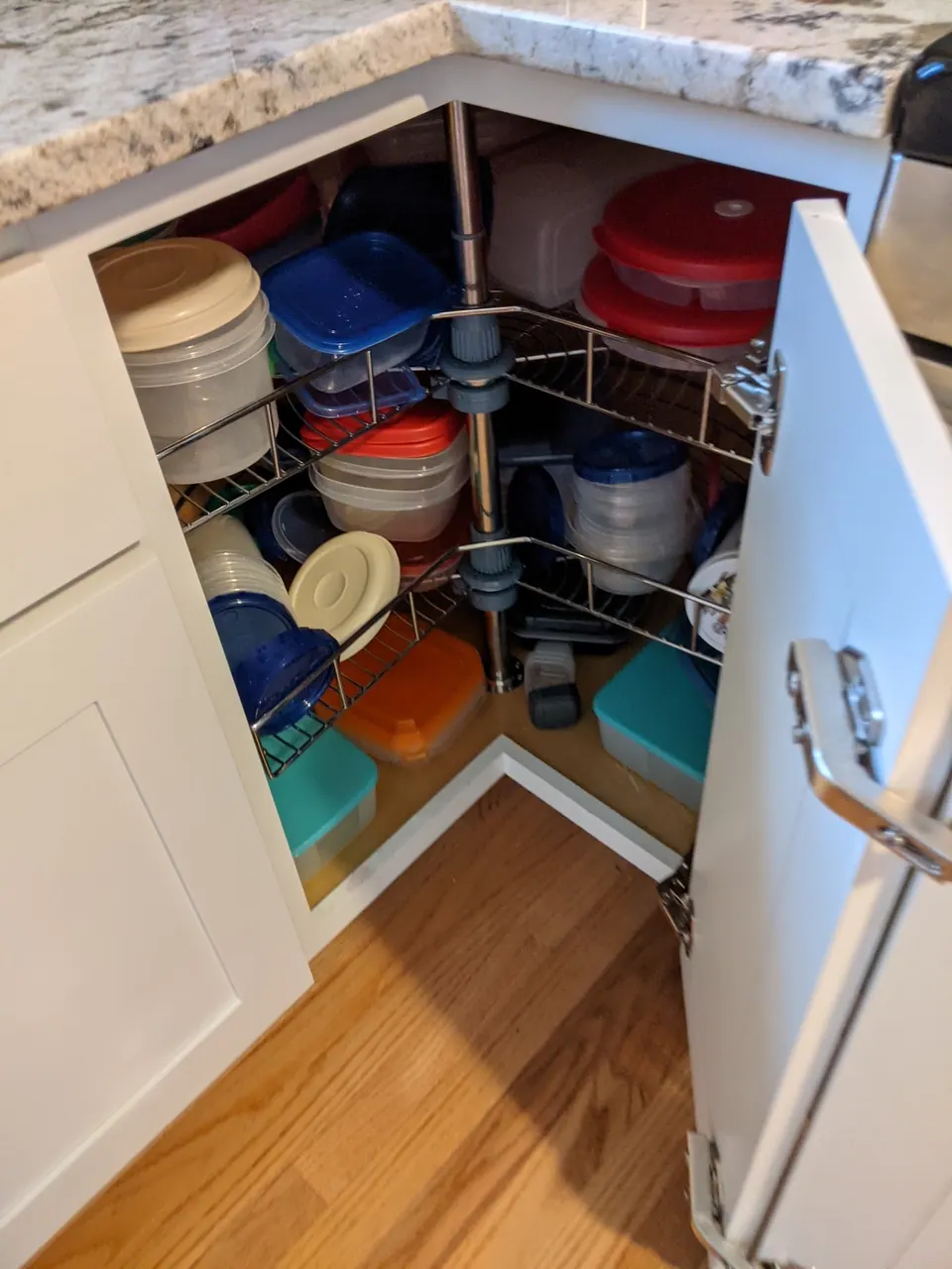 Corner base cabinet open with a lazy Susan.
