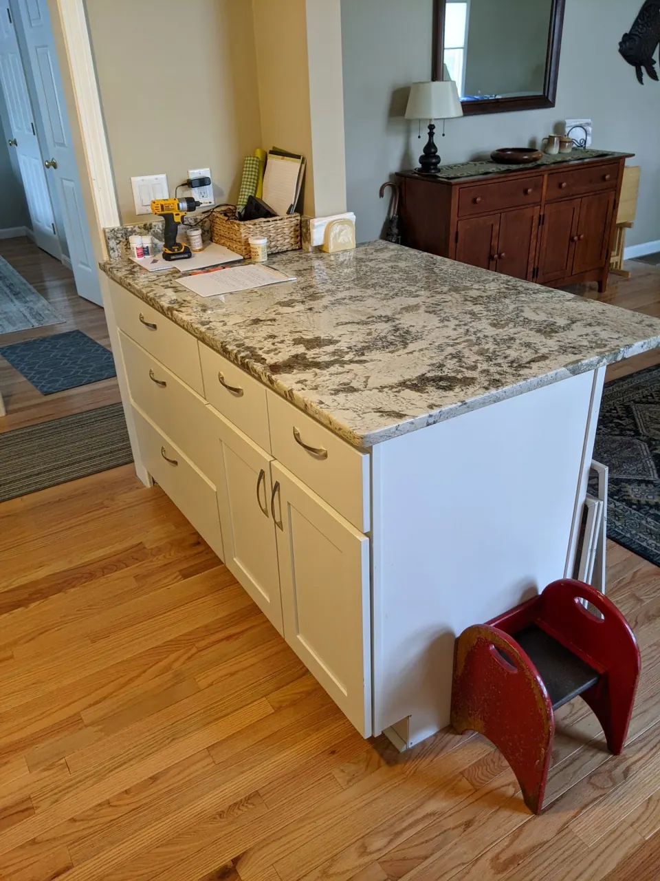End of the white peninsula with a granite top.
