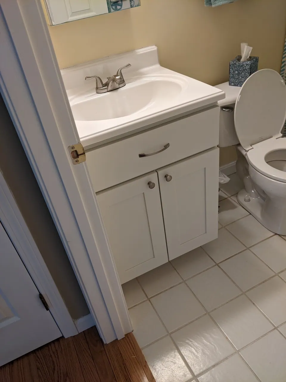 White bathroom vanity with a white top.