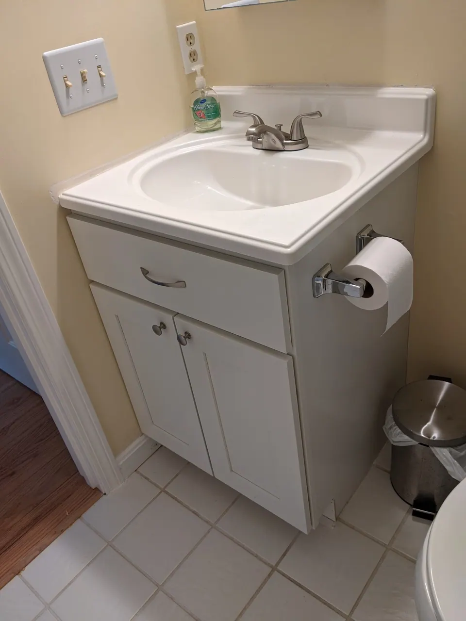 Small white vanity in the second bathroom.