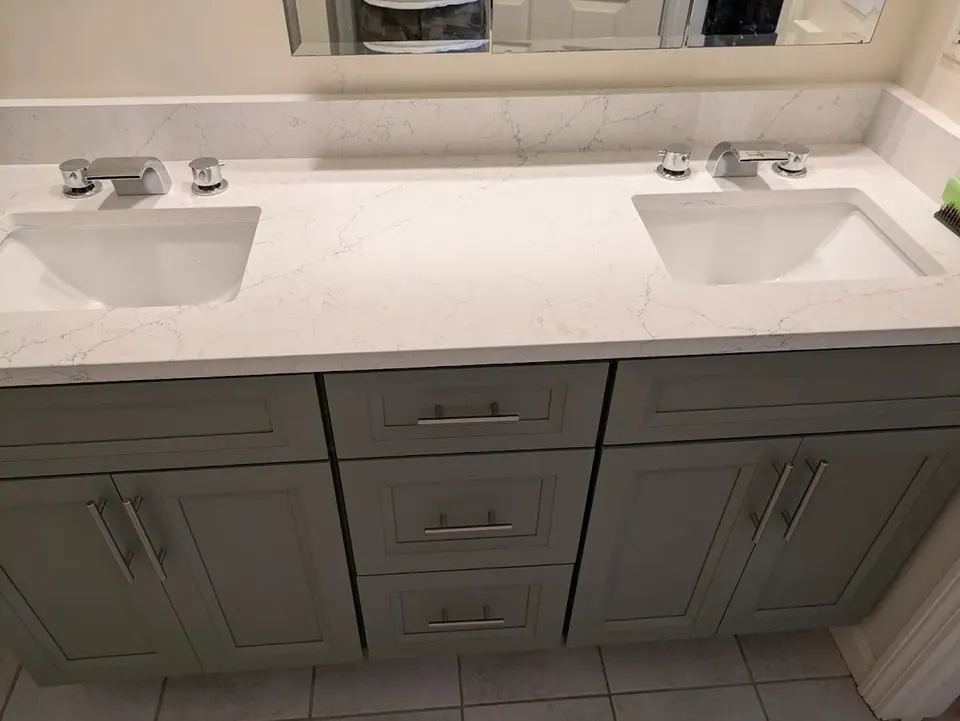 Bathroom: front of the double vanity with center drawers between two pairs of doors.