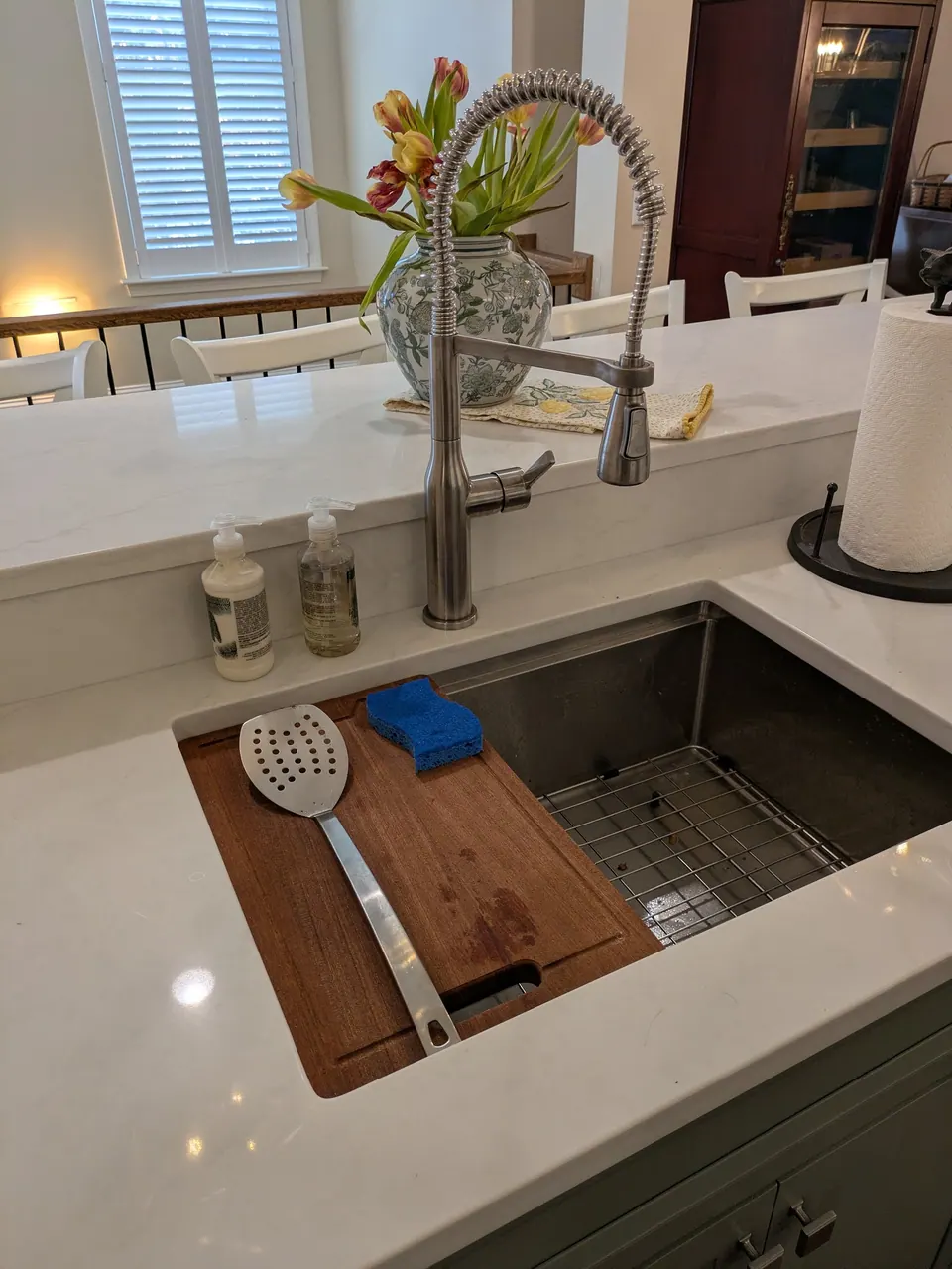Sink side of the island with a pull-down faucet and a stainless undermount sink.