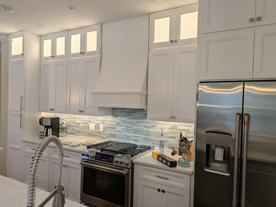 The kitchen from the sink, with the range wall and refrigerator.