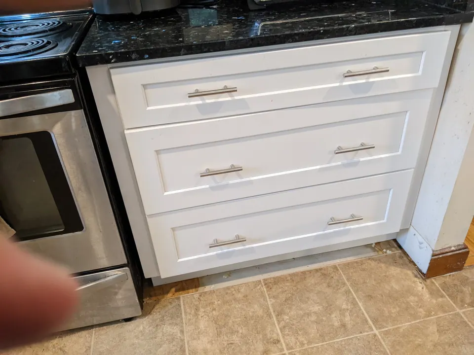 Deep white drawers next to the range.