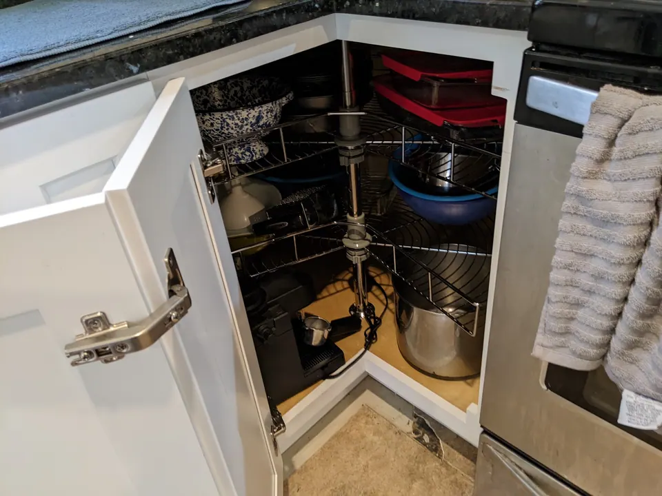 Corner cabinet open with a lazy Susan.