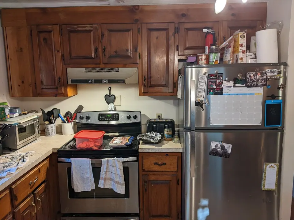 Before: dark wood cabinets around the range.