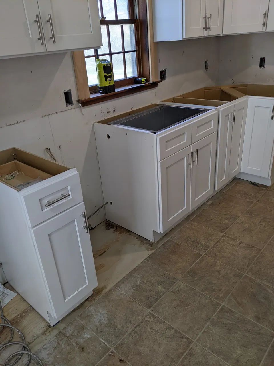 During the install: new white base cabinets, no counter yet.
