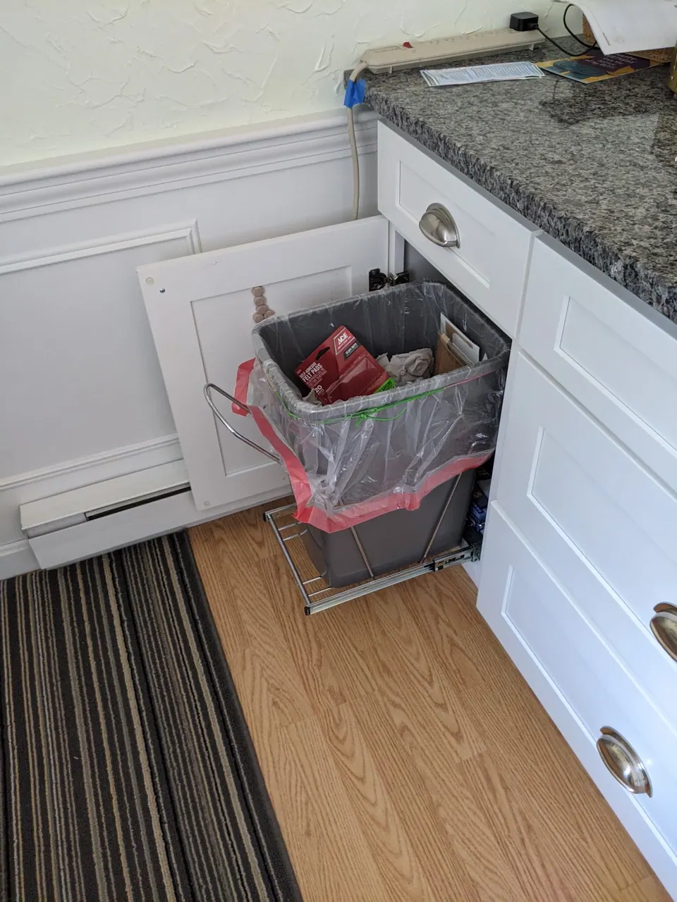 Pull-out trash base with two bins.