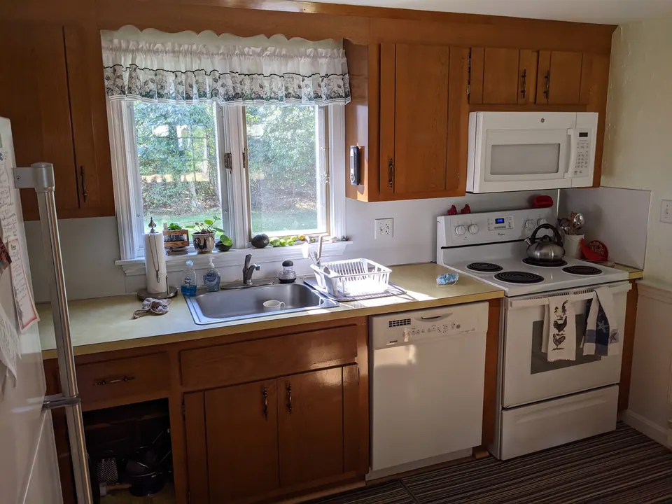 Before: oak cabinets around the sink window.